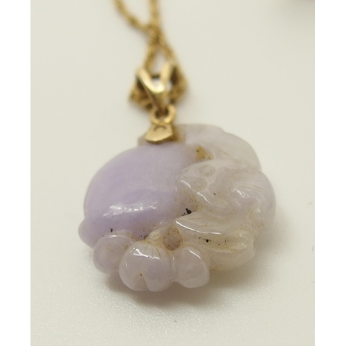 646 - A Chinese lilac coloured hardstone pendant and earrings