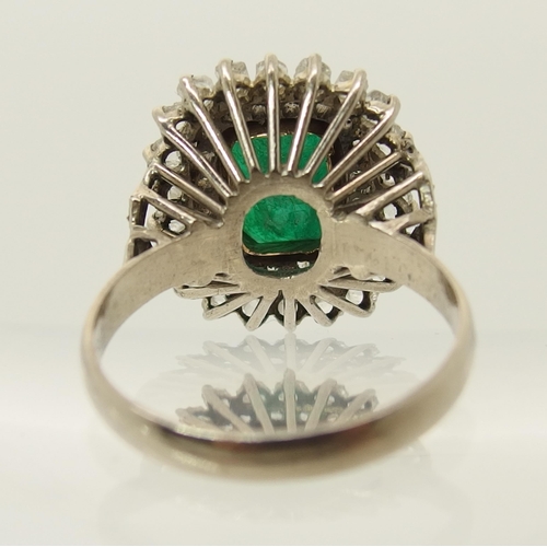 663 - An emerald and diamond cluster ring