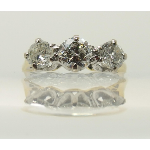 664 - An 18ct yellow and white gold three stone diamond ring