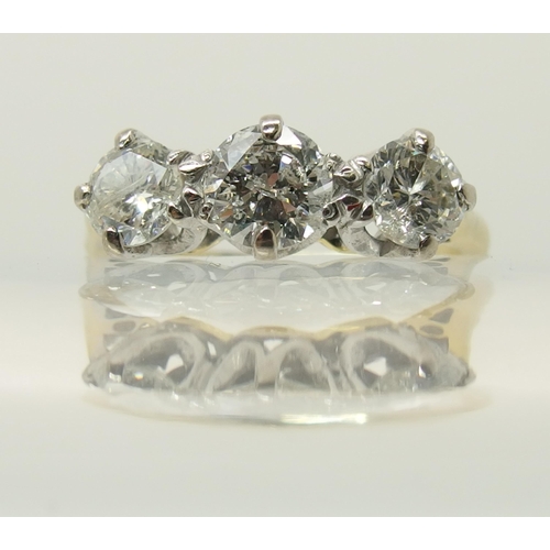 664 - An 18ct yellow and white gold three stone diamond ring