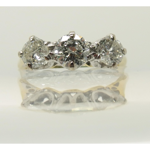 664 - An 18ct yellow and white gold three stone diamond ring