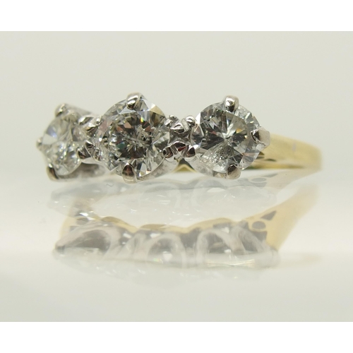 664 - An 18ct yellow and white gold three stone diamond ring