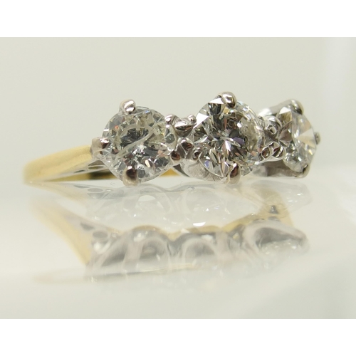 664 - An 18ct yellow and white gold three stone diamond ring