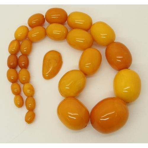 665 - A string of amber coloured beads