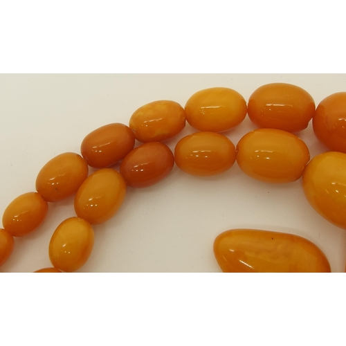 665 - A string of amber coloured beads