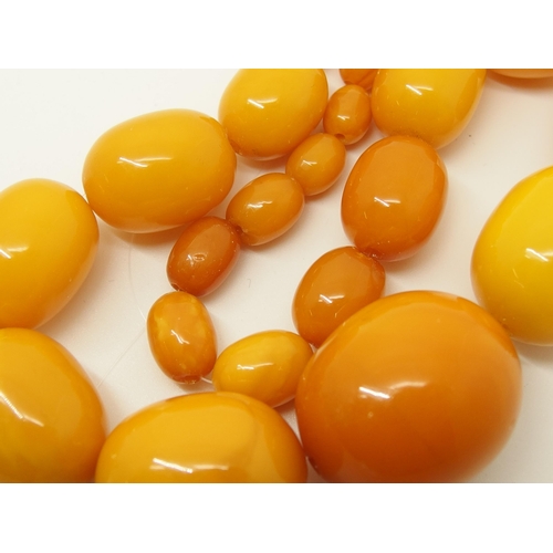 665 - A string of amber coloured beads