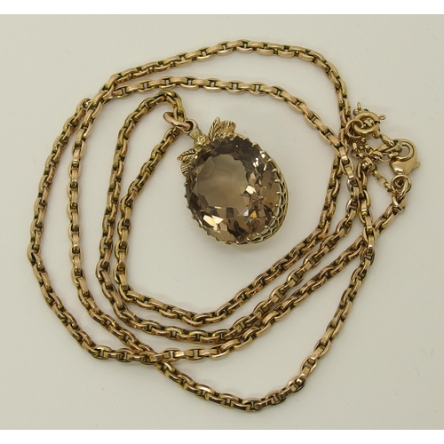 668 - A 9ct gold large smoky quartz pendant