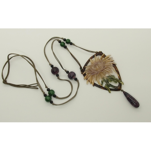 682 - An Art Nouveau carved and stained horn pendant necklace in the style of Madam Bonte