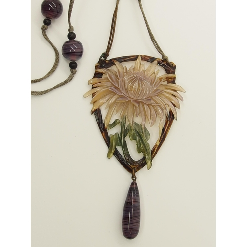 682 - An Art Nouveau carved and stained horn pendant necklace in the style of Madam Bonte