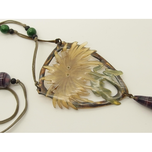 682 - An Art Nouveau carved and stained horn pendant necklace in the style of Madam Bonte