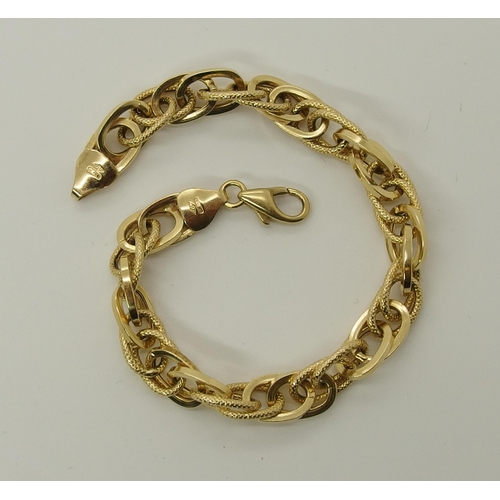 698 - An 18ct gold fancy link bracelet