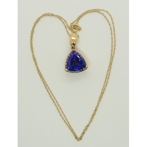 701 - An 18ct gold trilliant cut tanzanite and diamond pendant