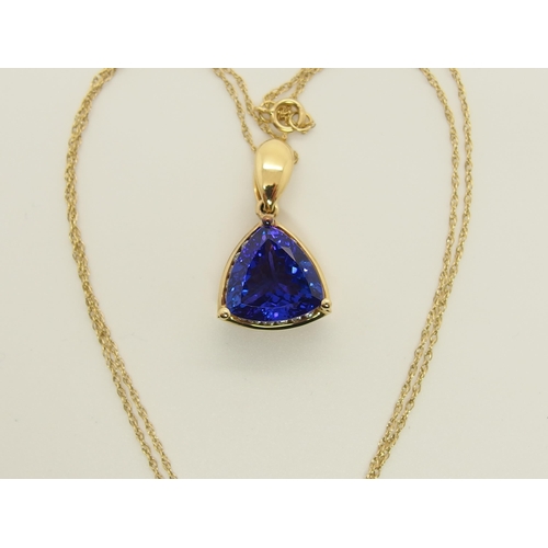 701 - An 18ct gold trilliant cut tanzanite and diamond pendant