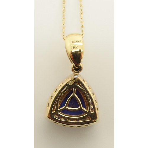 701 - An 18ct gold trilliant cut tanzanite and diamond pendant