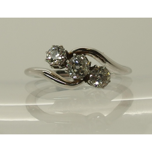 702 - An 18ct white gold three stone diamond ring