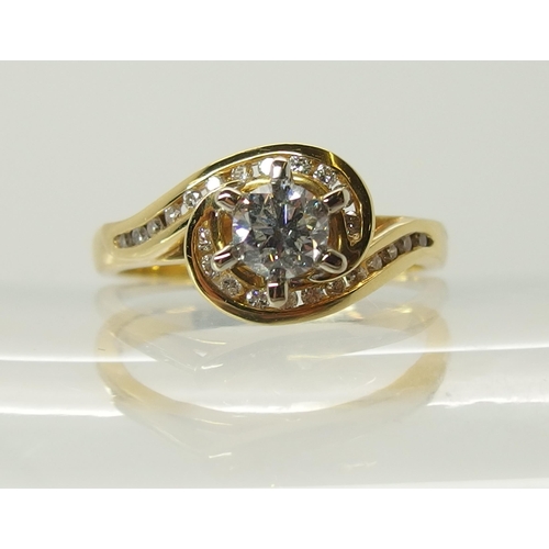 703 - An 18ct gold diamond ring of swirl design