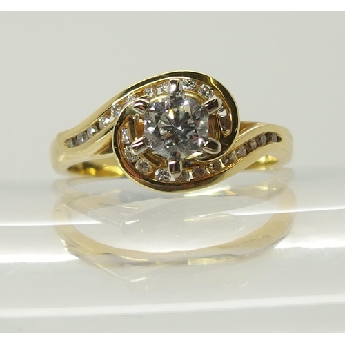 703 - An 18ct gold diamond ring of swirl design