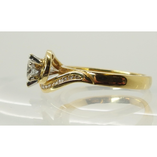 703 - An 18ct gold diamond ring of swirl design