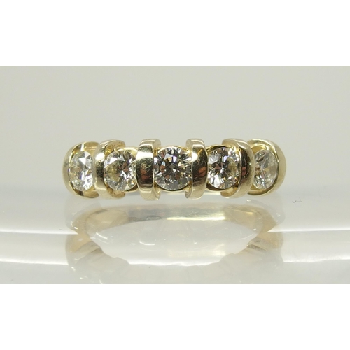 706 - A bright yellow metal five stone diamond ring