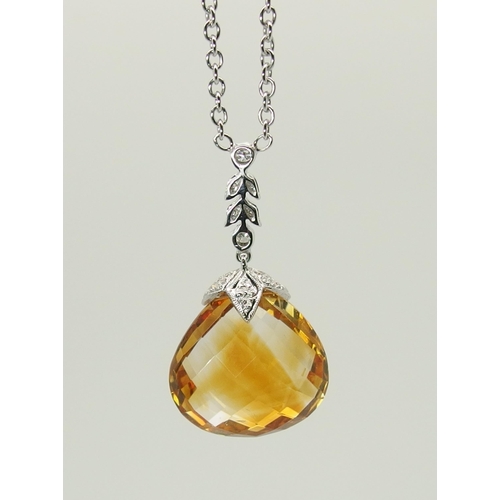 712 - A 18ct white gold citrine and diamond pendant