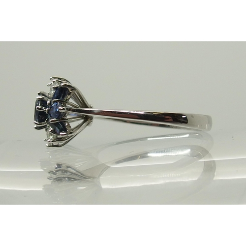 715 - An 18ct white gold sapphire and diamond cluster ring