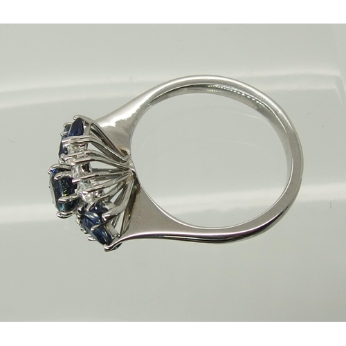 715 - An 18ct white gold sapphire and diamond cluster ring