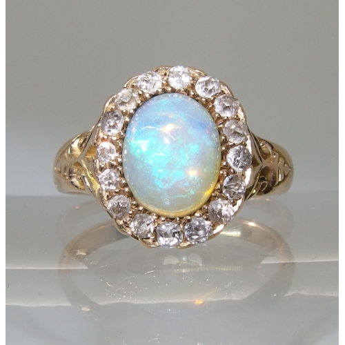 717 - An 18ct yellow gold jelly opal and old cut diamond ring