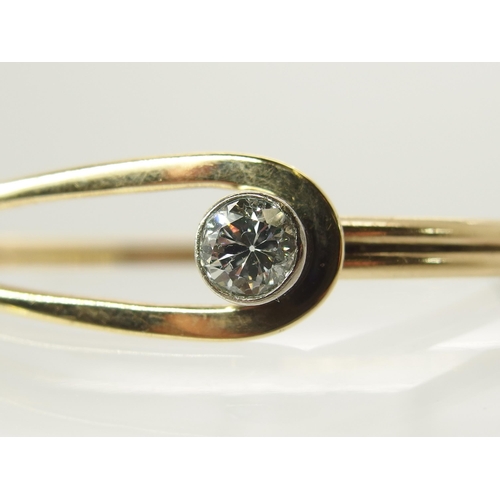 731 - A 9ct gold hand made bangle set with a diamond