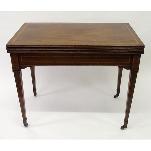 855 - An Edwardian mahogany and satinwood crossbanded games table