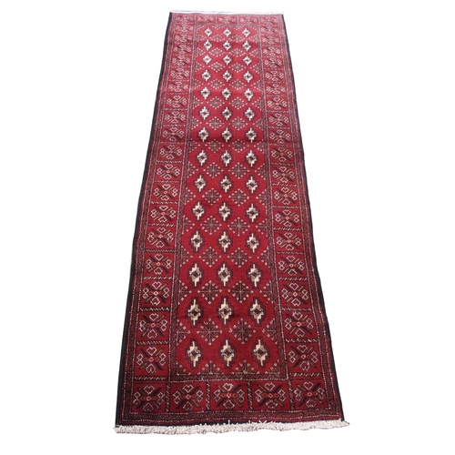 879 - A burgundy ground Turkman runner