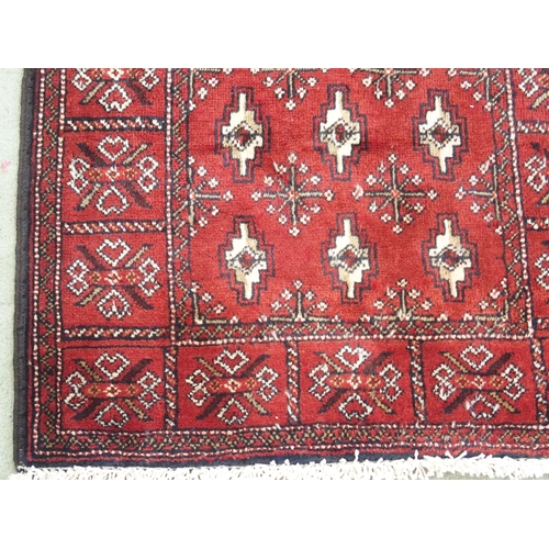 879 - A burgundy ground Turkman runner