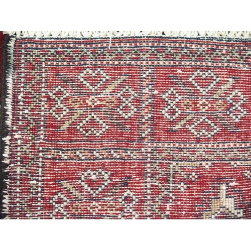 879 - A burgundy ground Turkman runner