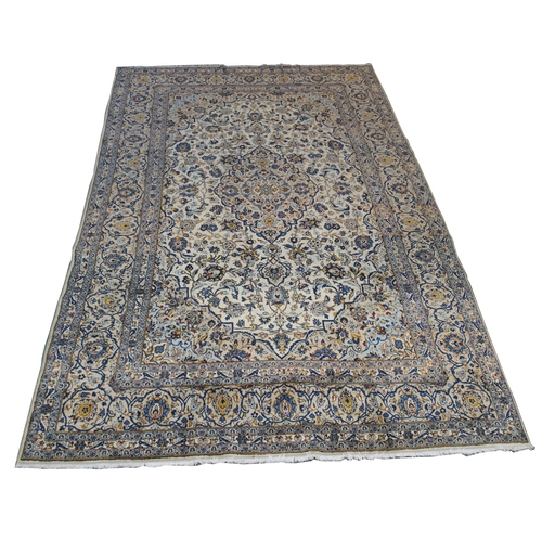 882 - A cream ground Kashan rug