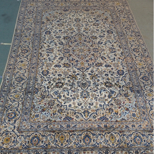 882 - A cream ground Kashan rug