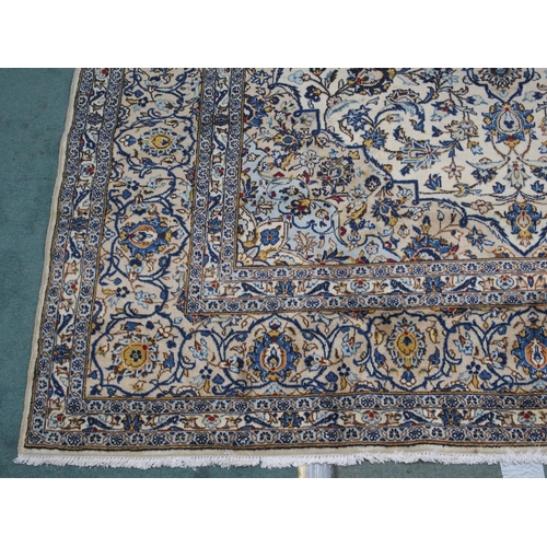 882 - A cream ground Kashan rug