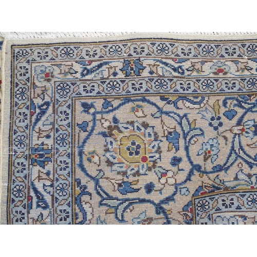 882 - A cream ground Kashan rug