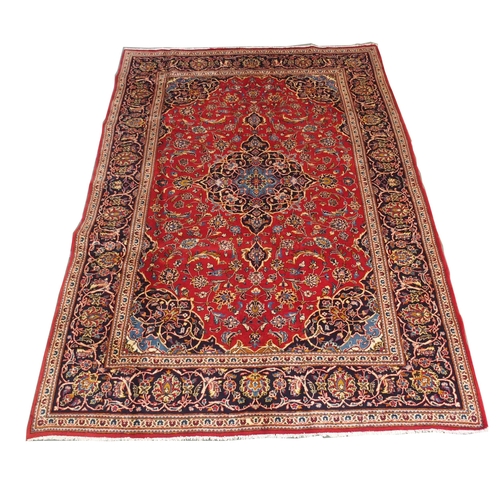 883 - A red ground Kashan rug