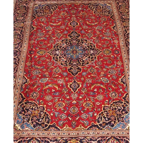 883 - A red ground Kashan rug