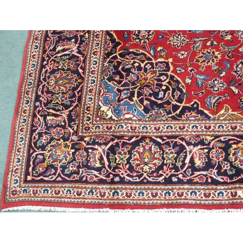 883 - A red ground Kashan rug