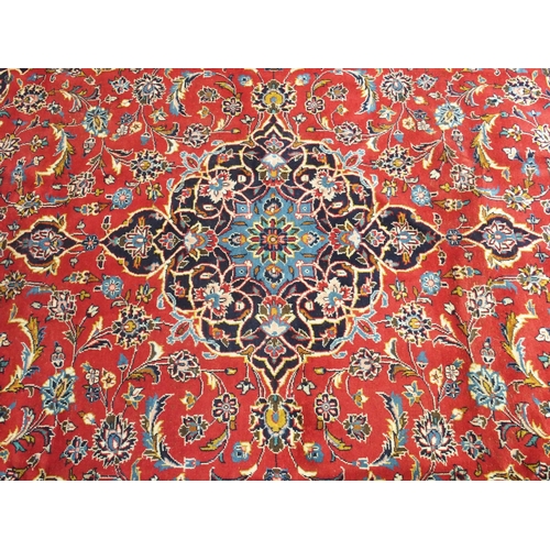 883 - A red ground Kashan rug