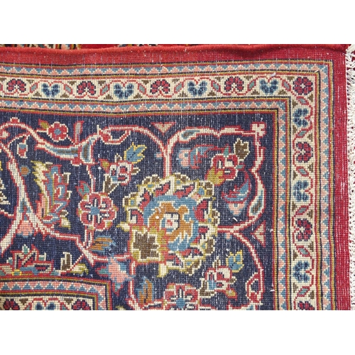 883 - A red ground Kashan rug