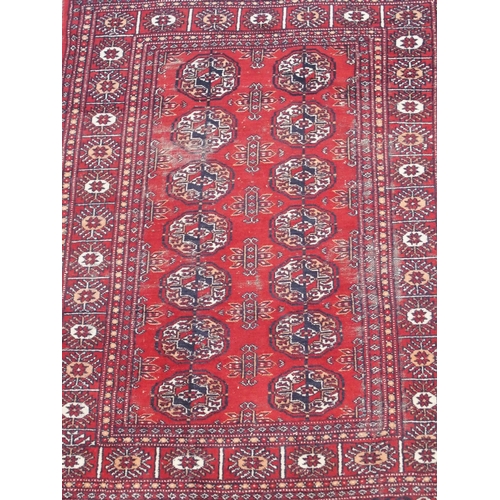 891 - A red ground Bokhara rug