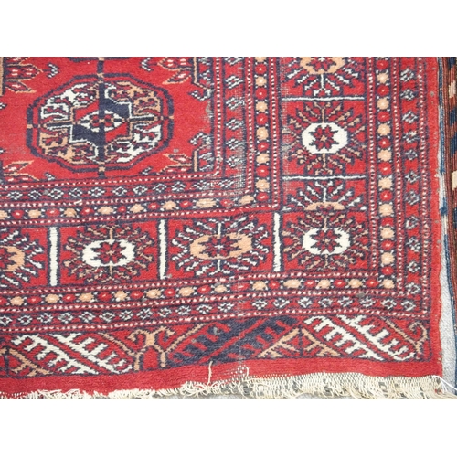 891 - A red ground Bokhara rug