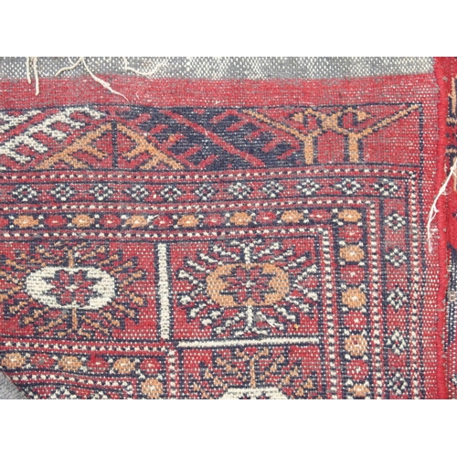 891 - A red ground Bokhara rug