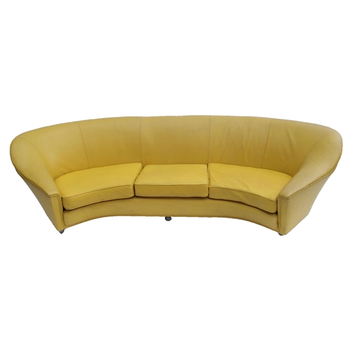 899 - A 1960's yellow leather crescent shaped three seater sofa