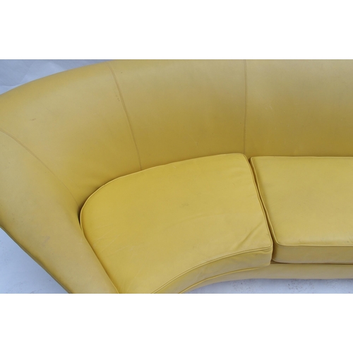 899 - A 1960's yellow leather crescent shaped three seater sofa