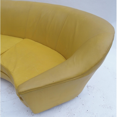 899 - A 1960's yellow leather crescent shaped three seater sofa