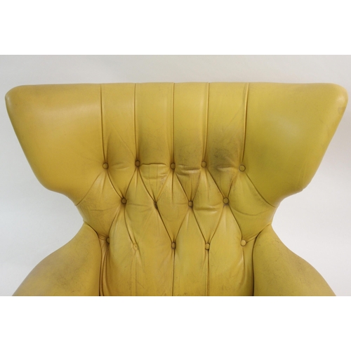 900 - A 1960's yellow leather button back swivel rocker