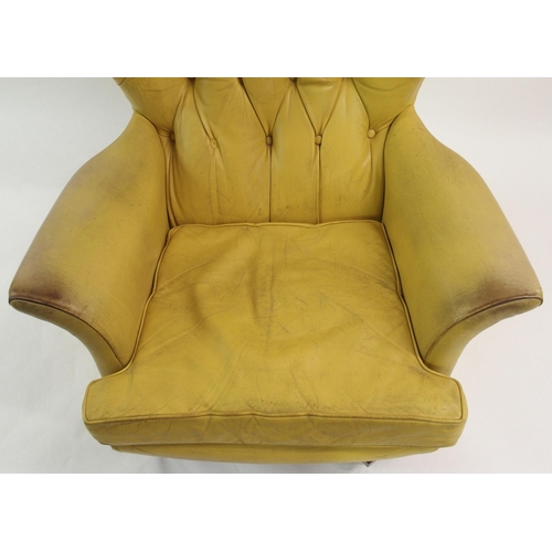 900 - A 1960's yellow leather button back swivel rocker