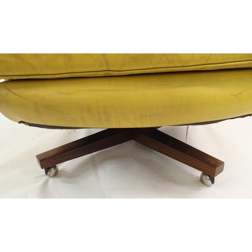 900 - A 1960's yellow leather button back swivel rocker